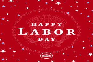 Ein Plakat mit "Happy Labor Day" in fetten, weißen Buchstaben auf einem hellroten Hintergrund, umgeben von farbigen Sternen verschiedener Größen.